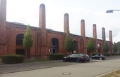 Die Federnschmiede gehört zu einem unter Denkmalschutz stehenden Gebäudeensemble des ehemaligen Ausbesserungswerks der Deutschen Bundesbahn in Burbach. (Foto: GIU Gesellschaft für Innovation und Unternehmensförderung mbH)