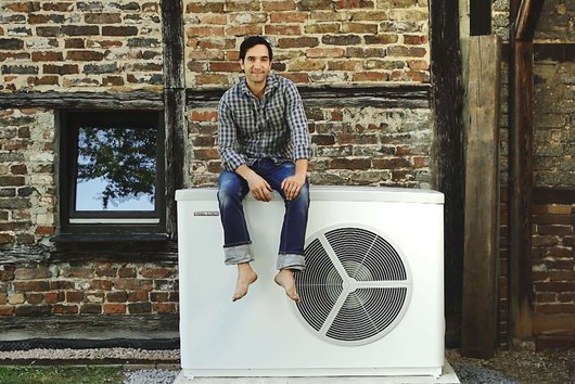 Schauspieler und Comedian Thomas Maximilian Held mit Luftwärmepumpe auf seinem Bauernhof in Mechernich. (Foto: Stiebel Eltron)
