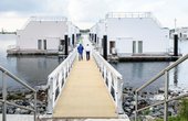 Über eine elegante Gangway sind die in skandinavischer Architektur gebauten Schwimmenden Häuser zu erreichen. (Foto: REMKO, Lage)